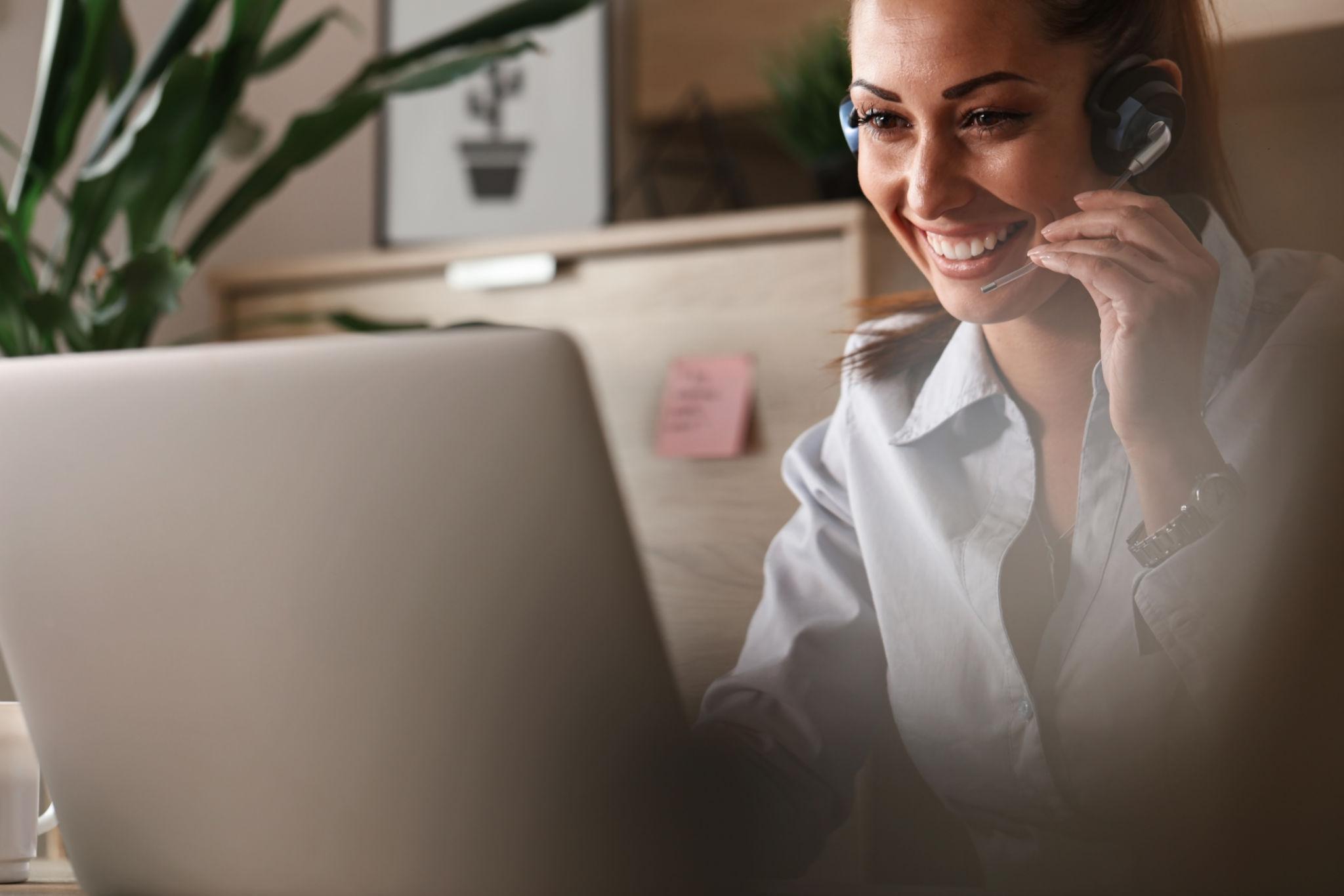 Instructor delivering a session over a laptop with headset
