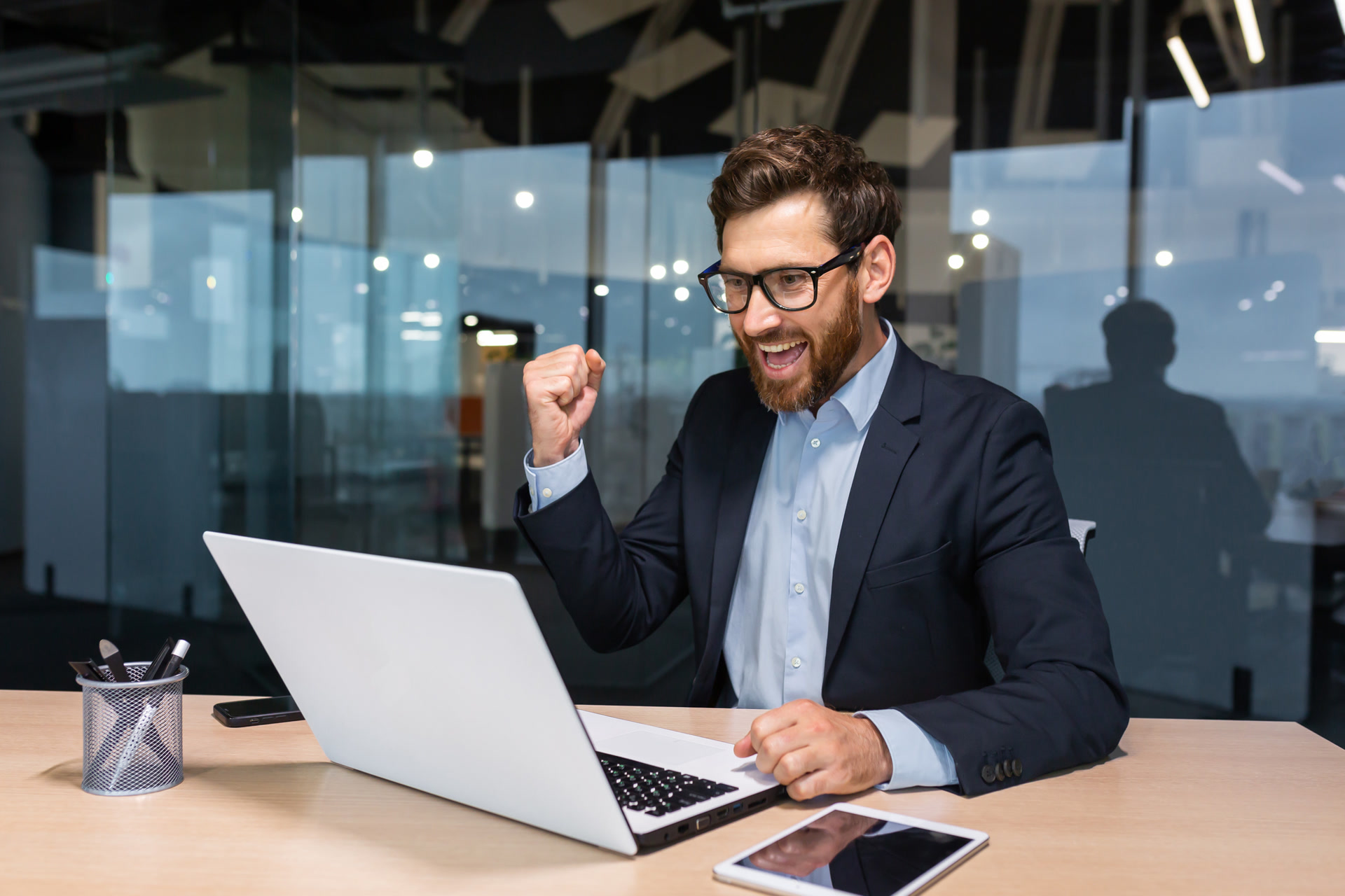 Professional celebrating progress at desk